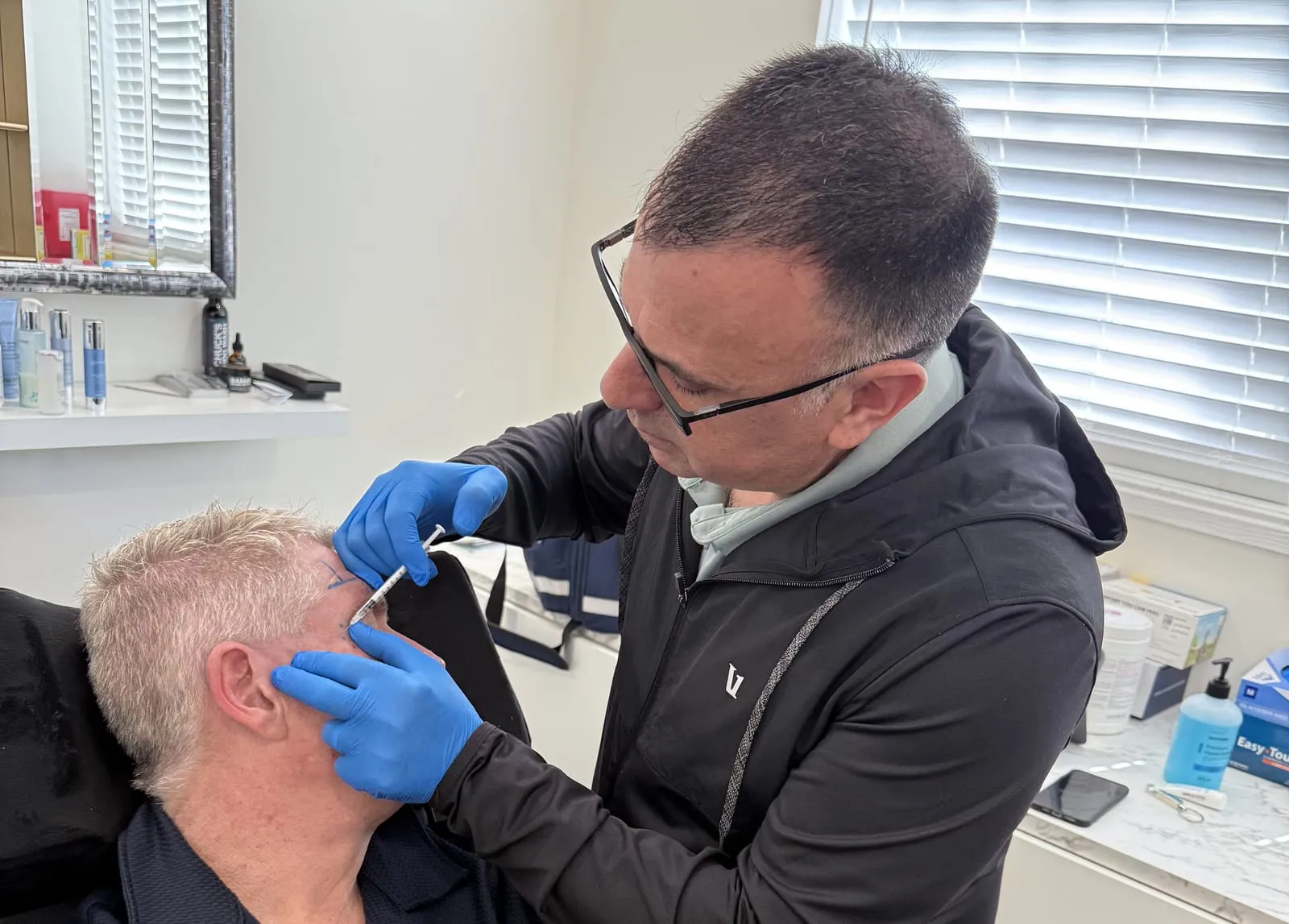 Brian Schwartz administering a wrinkle relaxer treatment