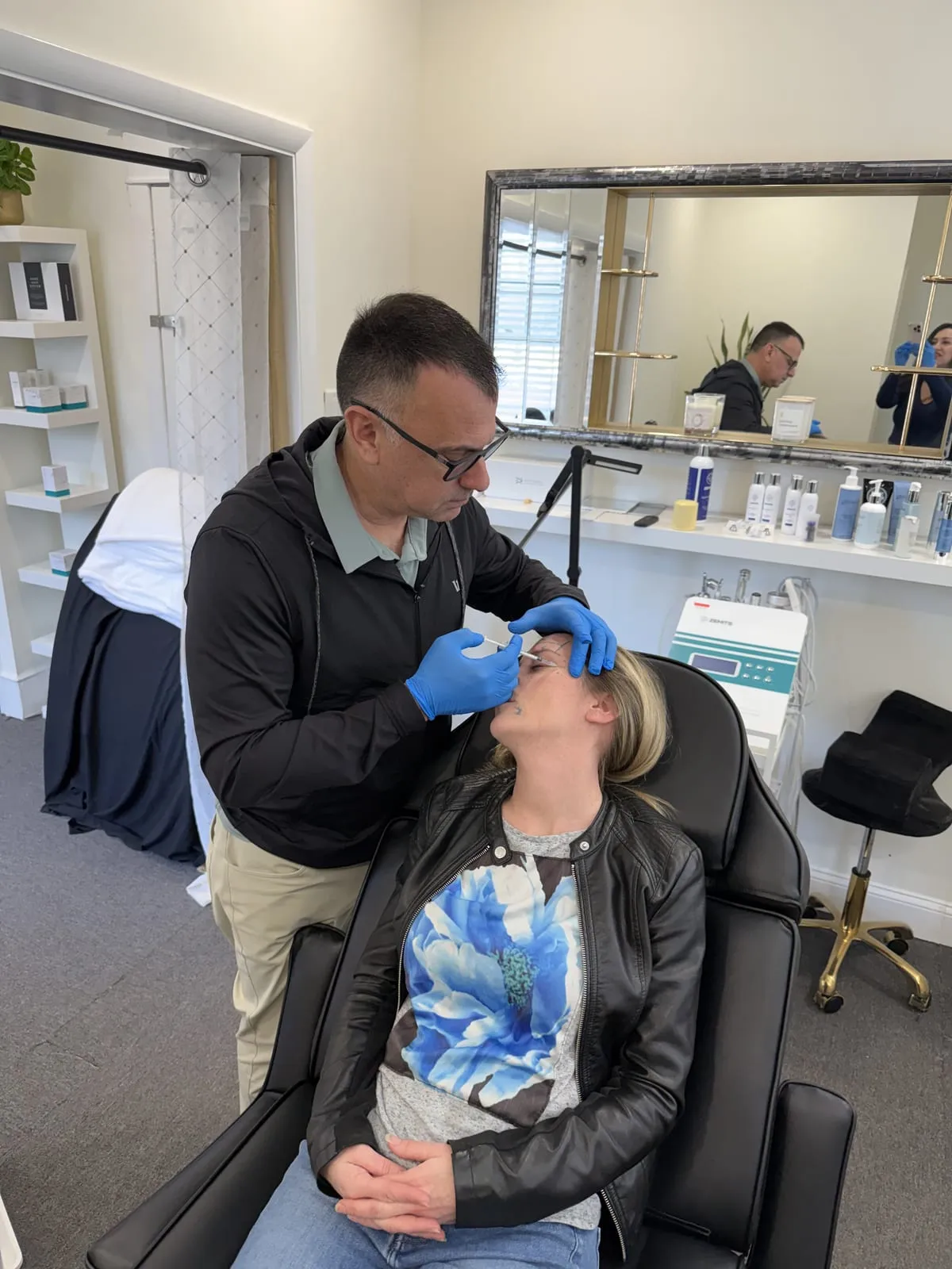 Brian Schwartz administering an aesthetic treatment at SPF Aesthetics
